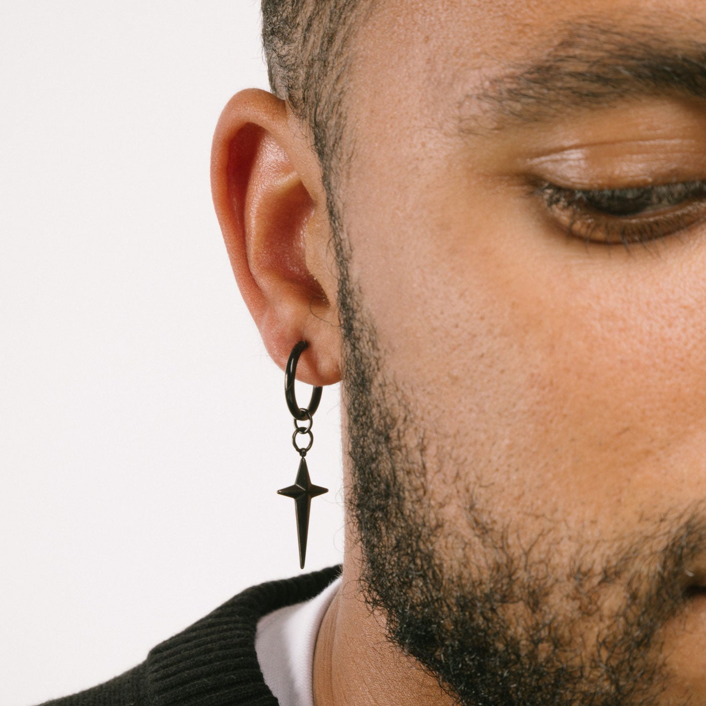 A model wearing the Altair Clip On Earrings offer a secure and adjustable closure that are perfect for those with thin ear lobes. Crafted with stainless steel and featuring non-tarnish and water-resistant properties, these earrings are hypoallergenic, lead and nickel free. The average comfortable wear duration is 2 to 4 hours. The item is sold as one pair.
