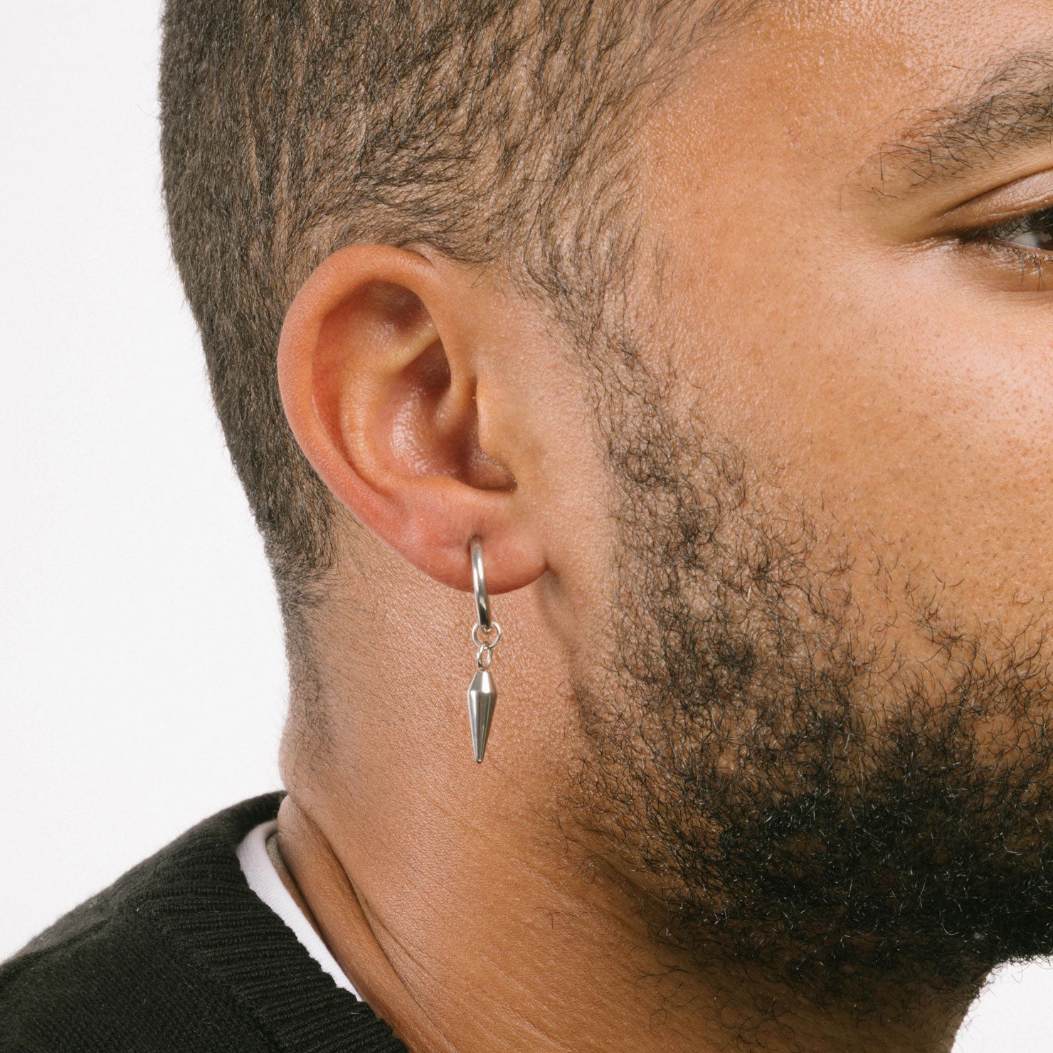 This set of three pairs of clip-on earrings for men features a secure sliding spring closure that best accommodates individuals with smaller or thinner earlobes. The average comfortable wear duration is approximately 2-4 hours, and the hold strength will remain very secure. The earrings are able to adjust to your ear thickness, and the materials are stainless steel. Included are a pair of dagger clip-on earrings, bar clip-on earrings, and classic hoop clip-on earrings (silver).