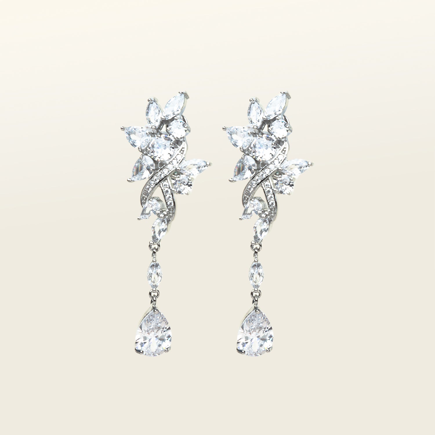 Image of the Evelyn Clip-On Earrings offer a secure fit for all ear types, ranging from thick/large ears to small/thin ears. With an average comfortable wear duration of 8-12 hours, these earrings have silver plated copper alloy components and feature a cubic zirconia setting. Additionally, the rubber padding is removable. Please note that this item is one pair.
