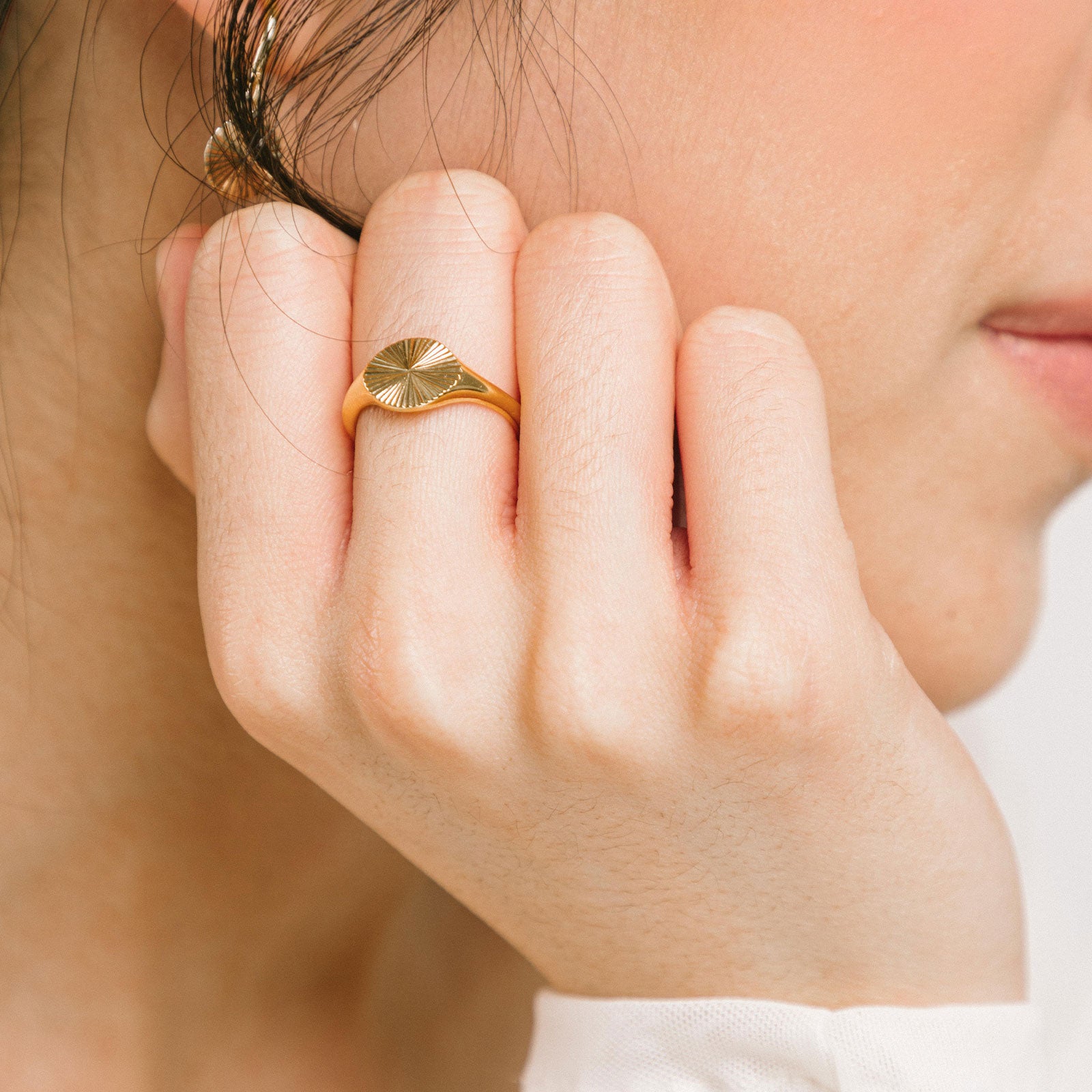 A model wearing the Sunbeam Ring is crafted out of 18K Gold Plated Stainless Steel, providing a non-tarnishing and water-resistant material. Please note, this ring is sold as a single item.
