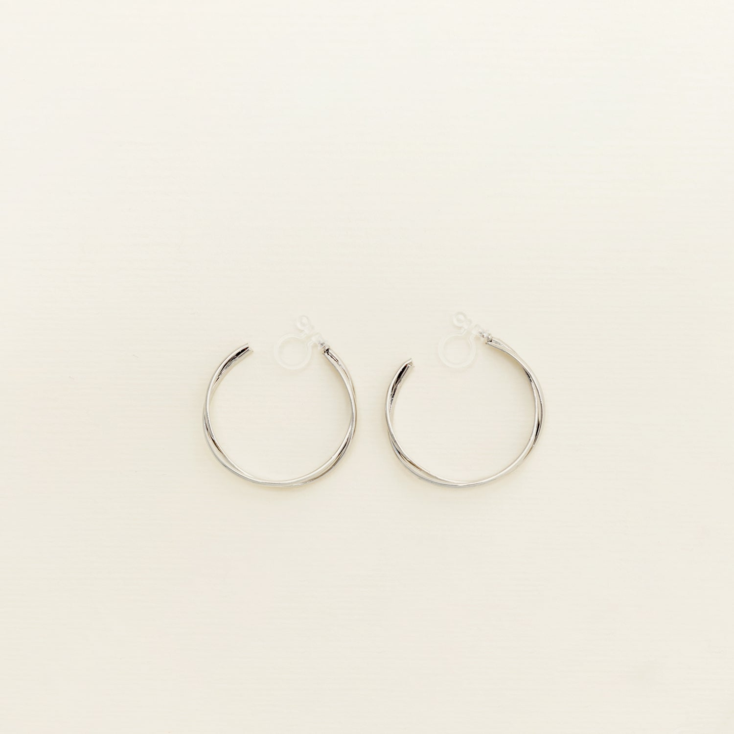 Image of the Silver Vienna Hoop Clip-On Earrings are crafted of Silver Tone Metal Alloy and feature a resin clip-on closure. These earrings are suited for all ear types, providing a medium-secure hold and an 8-12 hour average comfortable wear duration. Adjustment is not possible for this item; it is sold as a single pair in gold and silver.