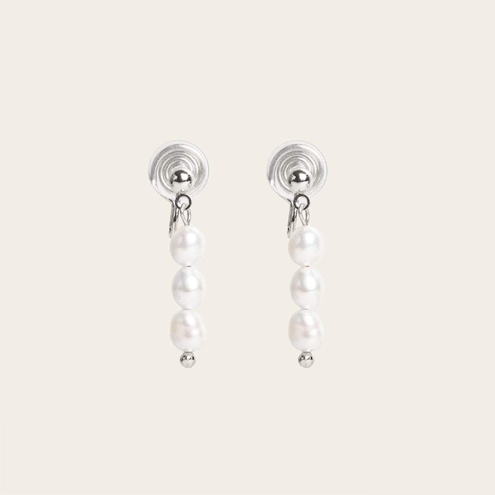 Image of the Audrey Clip On Earrings. These elegant earrings are adjustable for any ear type and provide a secure and comfortable hold for up to 24 hours. Perfect for sensitive or stretched ears, add a touch of sophistication to your daily style.