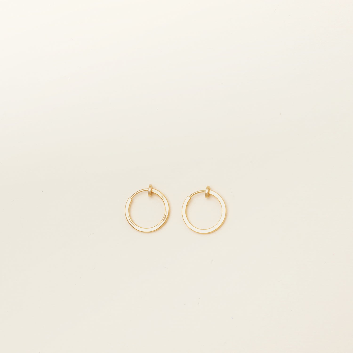 Image of the Mini Hoop Clip-On Earrings feature a sliding spring closure and are best suited for those with smaller or thinner ear lobes. On average, each pair can be comfortably worn for up to 4 hours, and provide a very secure hold that automatically adjusts to the ear thickness for a perfect fit. Crafted with stainless steel, each pair is sold individually.