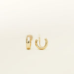 Image of the Small Hoop Clip On Earrings in Gold feature a mosquito coil closure for a secure hold of up to 24 hours. The earrings are designed to fit any ear type, including thick or large, sensitive, small or thin, and stretched or healing ears. They possess a medium secure hold and can be adjusted to fit the wearer's ear size, simply by gently squeezing the inner padding forward. Crafted from gold tone plated copper alloy, each package contains one pair.