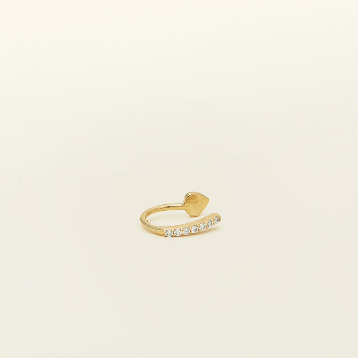 Image of the Thin Band Ear Cuff offers Medium Secure hold for up to 24 hours of comfortable wear. This ear cuff can be adjusted slightly once on the ear, and is ideal for all ear types, including thick/large ears, sensitive ears, small/thin ears, and stretched/healing ears. It is crafted from gold or silver plated copper alloy, with Cubic Zirconia for sparkle. This one-piece ear cuff also doubles as a faux nose piercing.