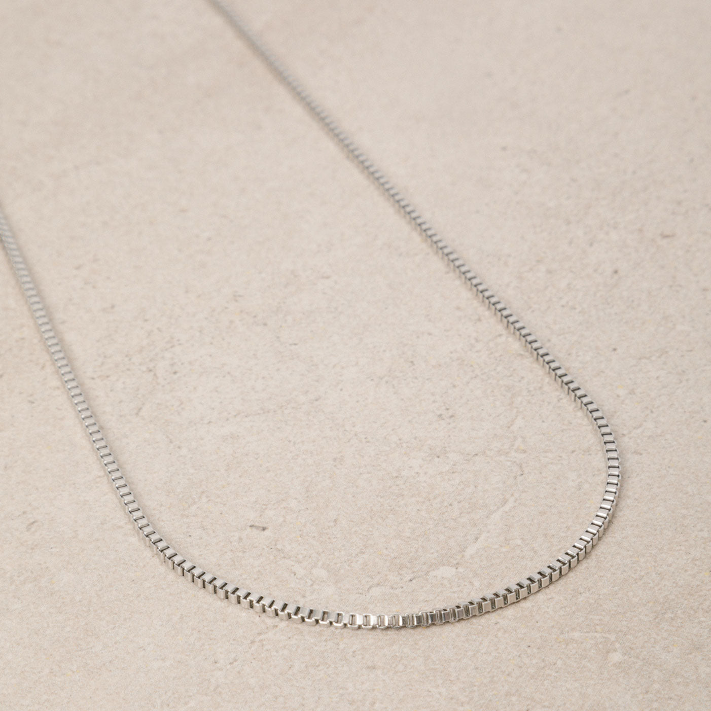 Image of the 2mm Square Box Chain crafted from high-grade Stainless Steel, measuring 22 inches / 56 cm in length and 2 mm in width. Weighing 5.8 grams, this chain is non-tarnishing and water-resistant.