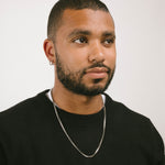 A model wearing the 3.5mm Square Box Chain crafted from high-grade Stainless Steel, measuring 22 inches / 56 cm in length and 2 mm in width. Weighing 5.8 grams, this chain is non-tarnishing and water-resistant.