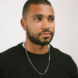 A model wearing the 3.5mm Square Box Chain crafted from high-grade Stainless Steel, measuring 22 inches / 56 cm in length and 2 mm in width. Weighing 5.8 grams, this chain is non-tarnishing and water-resistant.