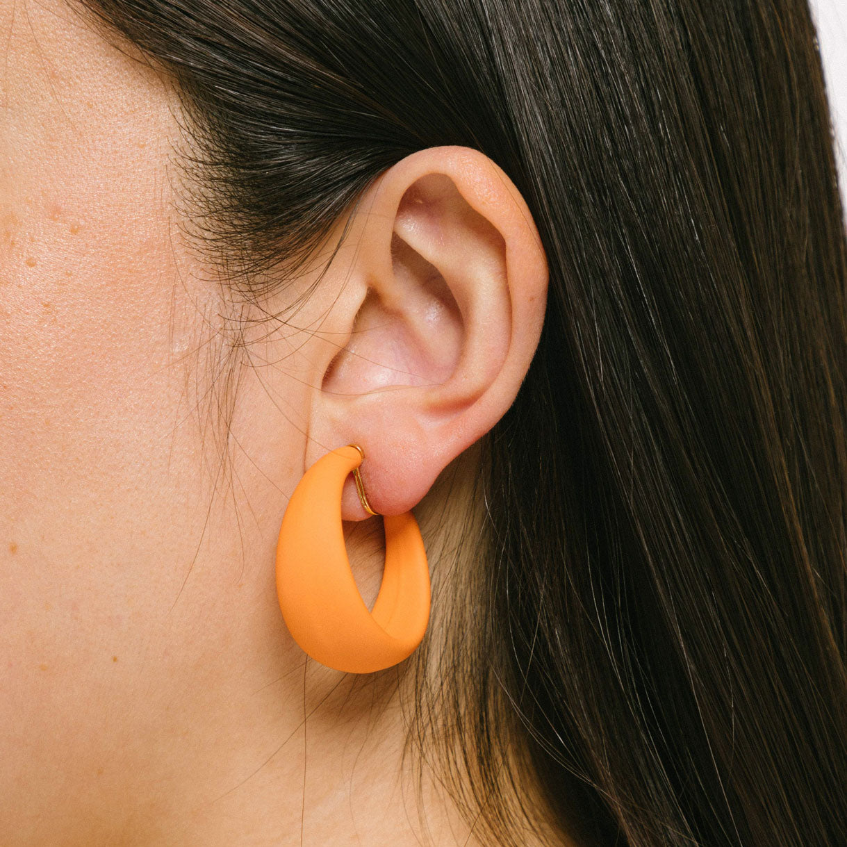 Eye-catching orange clip-on earrings with screwback closure, suitable for all ear types - thick, sensitive, small, and stretched/healing ears. Provides a secure hold and can be manually adjusted. 