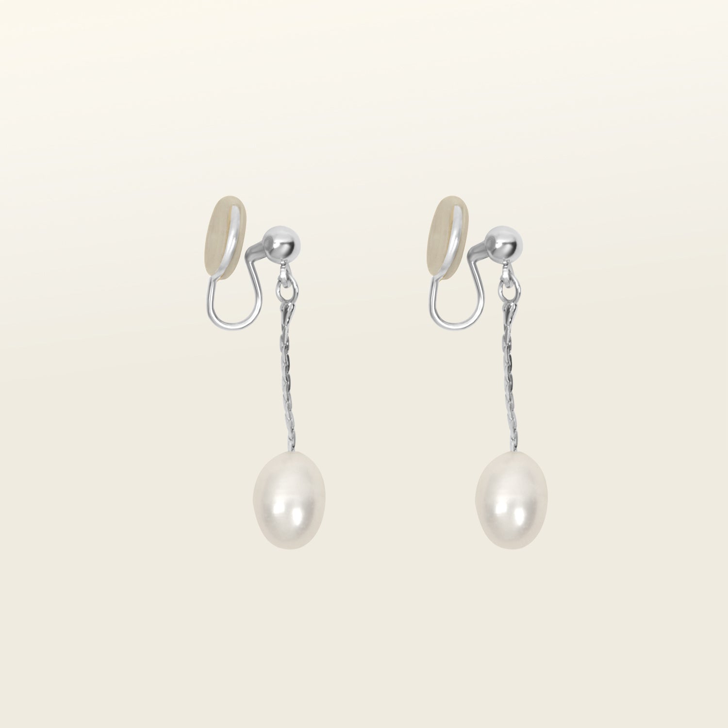 Silver-plated brass mosquito coil clip-on earrings adorned with lustrous freshwater pearls. Suitable for all ear types, offering a medium secure hold for comfortable 24-hour wear.