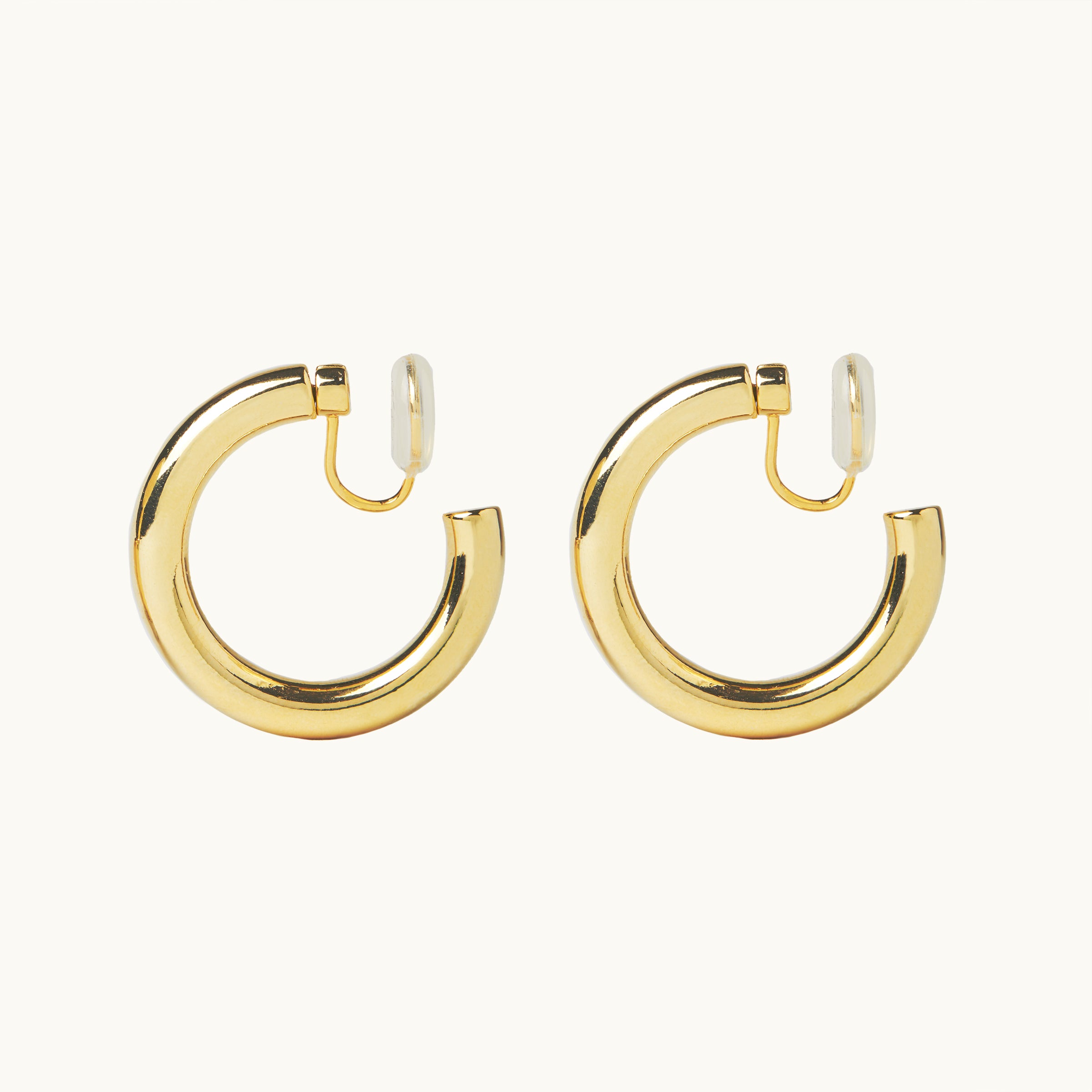 Image of the Allie Hoop Clip On Earrings in Gold, which are perfect for all ear types. The Mosquito Coil Clip-On Closure is suitable for Thick/Large, Sensitive, Small/Thin, Stretched/Healing, and Keloid Prone Ears. Made of a Gold tone copper alloy, each purchase includes one pair.