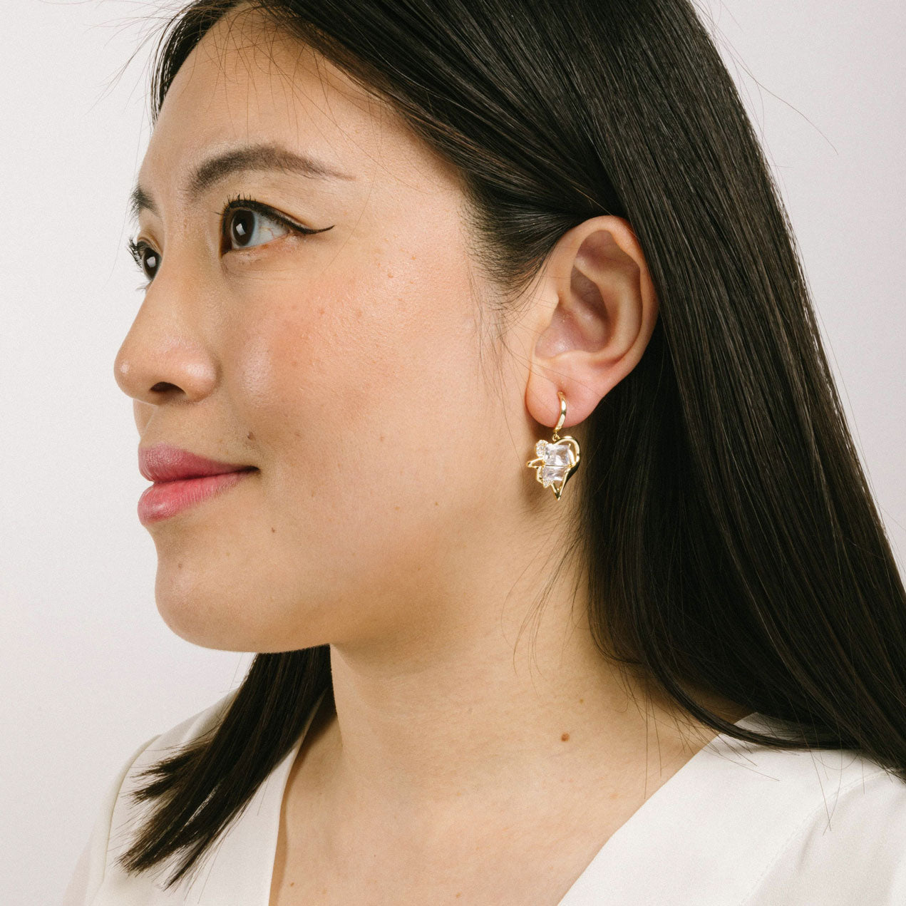 A model wearing the Amaretto Clip On Earrings feature a Mosquito Coil Clip-On closure type, making them ideal for all ear types, from Thick/Large Ears to Sensitive ones and Small/Thin Ears to Stretched/Healing Ears. Average wear duration can be up to 24 hours with a medium secure hold, and they can be gently adjusted by squeezing the padding forward once on the ear. The materials used in their construction areCubic Zirconia and Copper. Please note, item is only one pair.