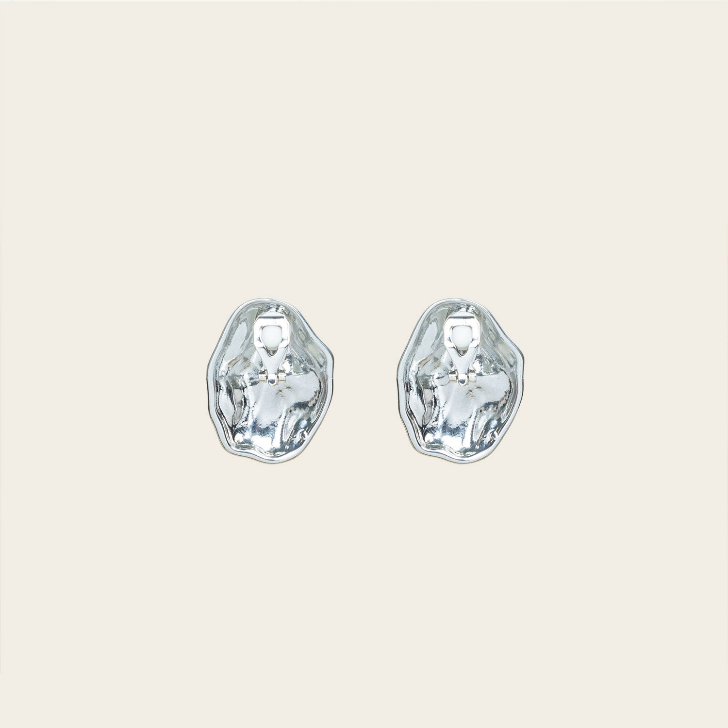 Image of the Amaya Clip On Earrings in Silver feature a secure padded clip-on closure type, making them suitable for all ear types.The average comfortable wear duration is 8-12 hours, and the Copper Alloy construction ensures a reliable and secure hold. The item is sold as one pair; adjustable rubber padding is included.