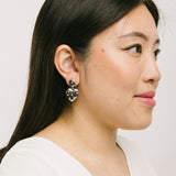 Image of the Amore Clip On Earrings in Silver offer a secure, padded closure type for a comfortable wear of 8-12 hours that is suitable for all ear types. This single pair features stainless steel and cubic zirconia construction and is non-tarnish and water resistant. Note: The clip-on earring has removable rubber padding.