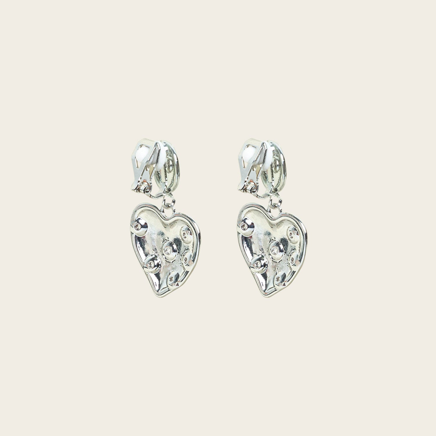 Image of the Amore Clip On Earrings in Silver offer a secure, padded closure type for a comfortable wear of 8-12 hours that is suitable for all ear types. This single pair features stainless steel and cubic zirconia construction and is non-tarnish and water resistant. Note: The clip-on earring has removable rubber padding.