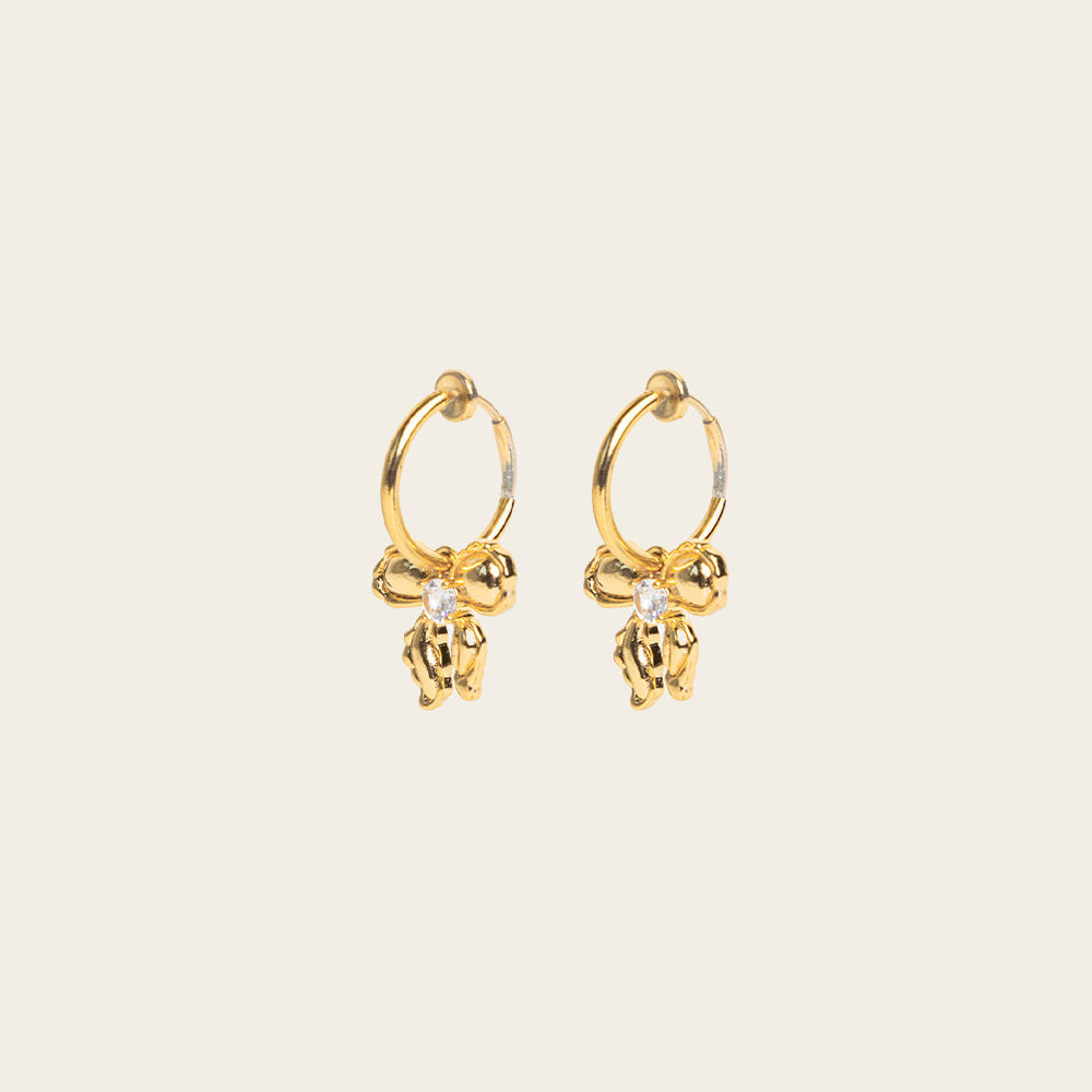 Image of the Ares Clip On Earrings. The sliding spring closure allows for easy adjustment to fit any ear thickness, while the gold tone copper alloy provides a secure hold. Perfect for stretched/healing ears or small/thin earlobes.
