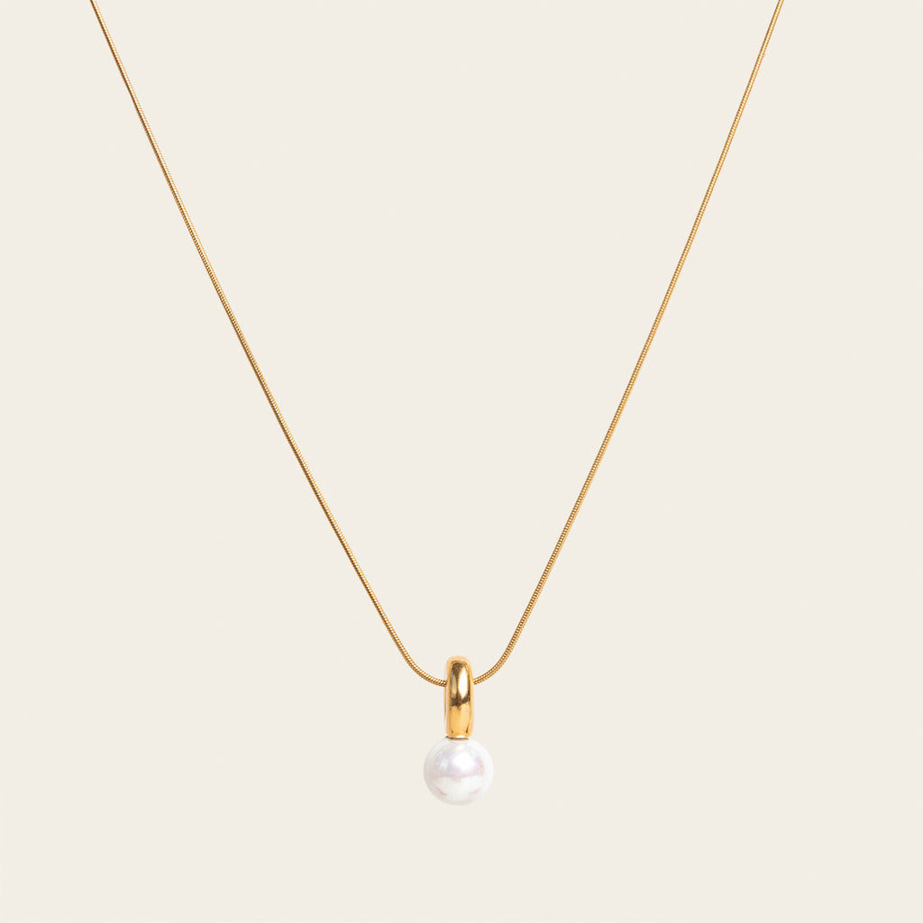 Image of the Ariel Pearl Necklace boasts a Mother of Pearl Pendant for a timeless and enduring beauty. Resilient against tarnishing and water, this necklace exudes confidence and sophistication. Perfect for any occasion.