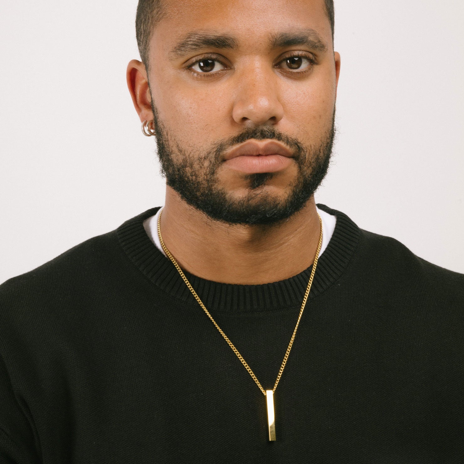 A model wearing the Bar Pendant Chain is crafted with corrosion-resistant Stainless Steel, making it durable, non-tarnish, and water-resistant.