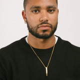 A model wearing the Bar Pendant Chain is crafted with corrosion-resistant Stainless Steel, making it durable, non-tarnish, and water-resistant.