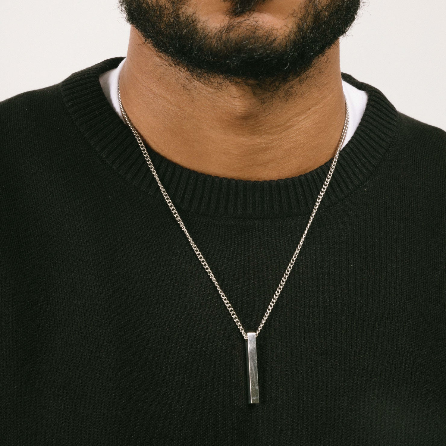 A model wearing the Bar Pendant Chain is crafted with corrosion-resistant Stainless Steel, making it durable, non-tarnish, and water-resistant.