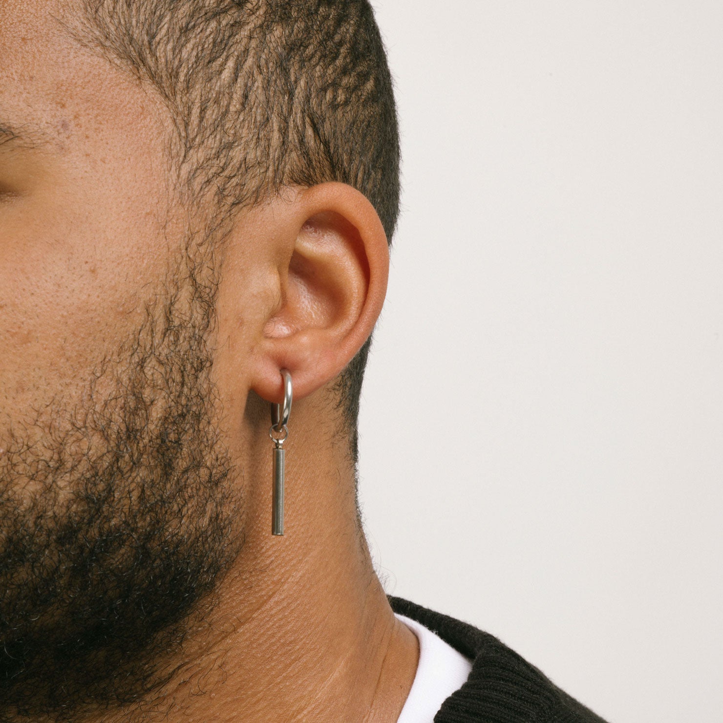 This set of three pairs of clip-on earrings for men features a secure sliding spring closure that best accommodates individuals with smaller or thinner earlobes. The average comfortable wear duration is approximately 2-4 hours, and the hold strength will remain very secure. The earrings are able to adjust to your ear thickness, and the materials are stainless steel. Included are a pair of dagger clip-on earrings, bar clip-on earrings, and classic hoop clip-on earrings (silver).