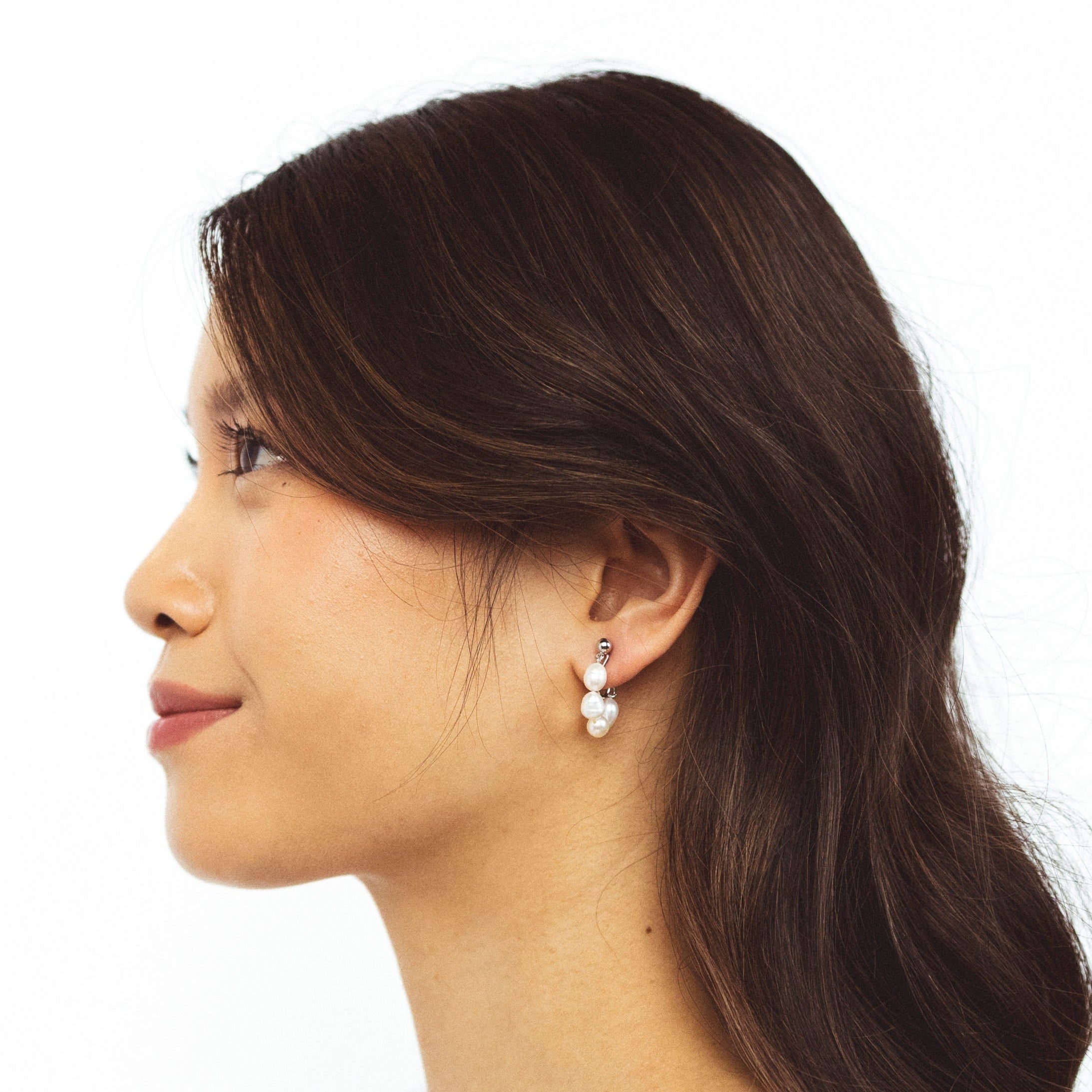 A model wearing the Blair Clip On Earrings. Our earrings offer a secure 24-hour hold and adjustable fit for all ear types, ideal for sensitive or stretched ears. Elevate your everyday ensemble with a touch of sophistication.