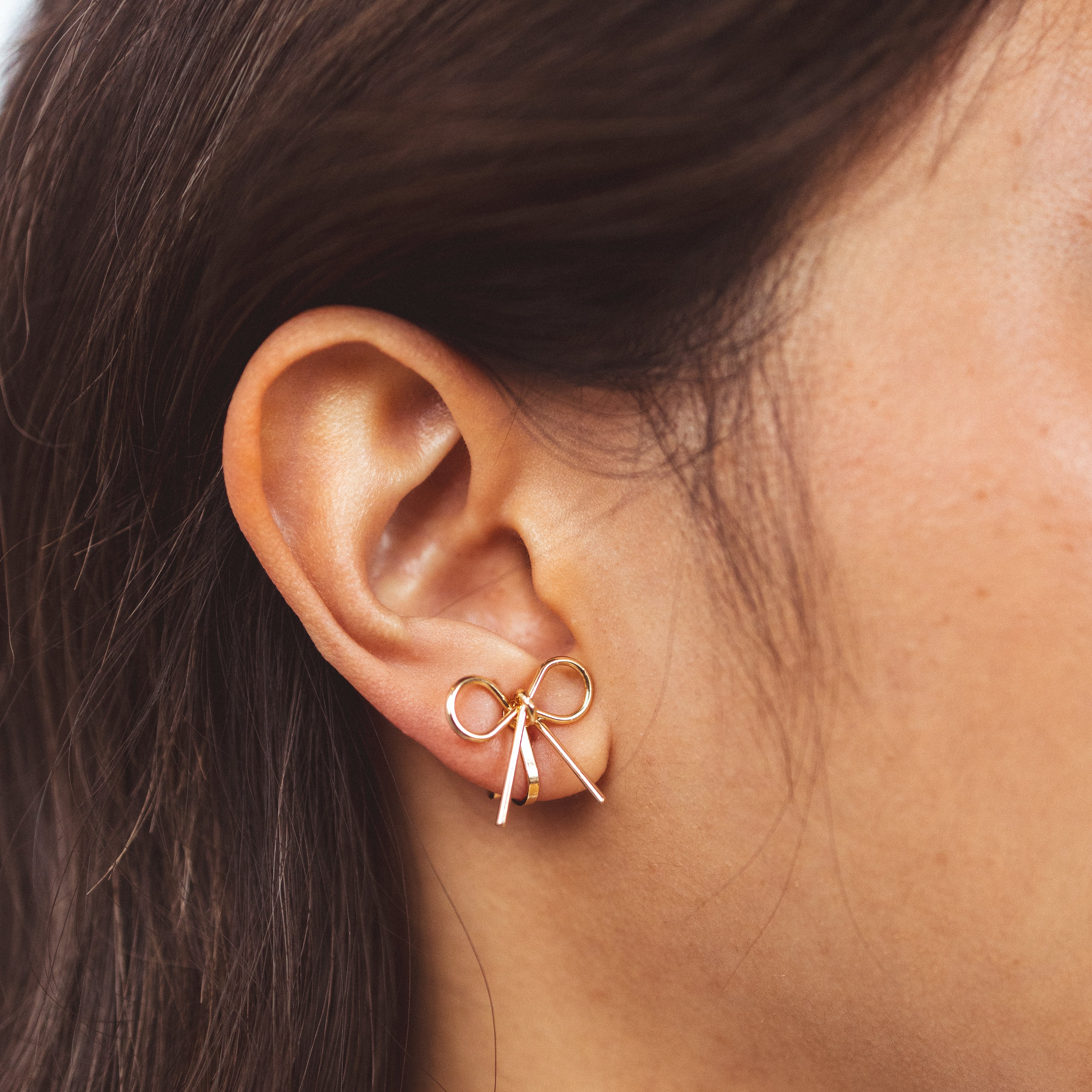 A model wearing the Celia Clip On Earrings. Designed with a 24-hour hold and adjustable fit, these earrings are perfect for sensitive or stretched ears. Elevate your style with elegance and comfort.