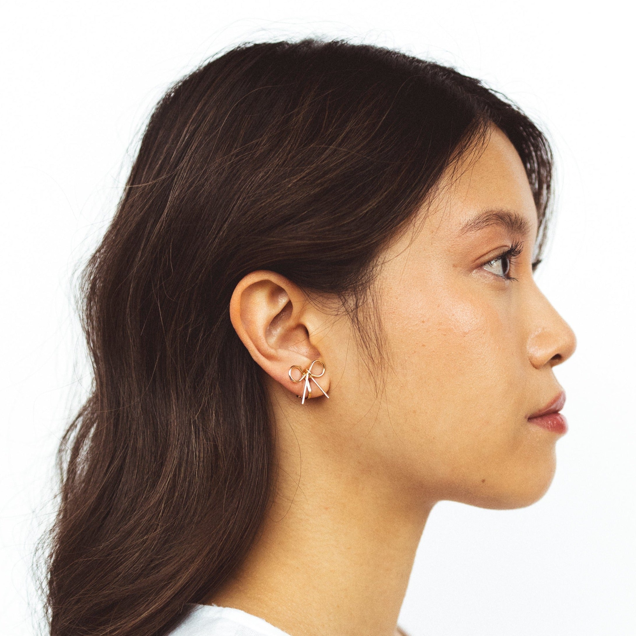 A model wearing the Celia Clip On Earrings. Designed with a 24-hour hold and adjustable fit, these earrings are perfect for sensitive or stretched ears. Elevate your style with elegance and comfort.
