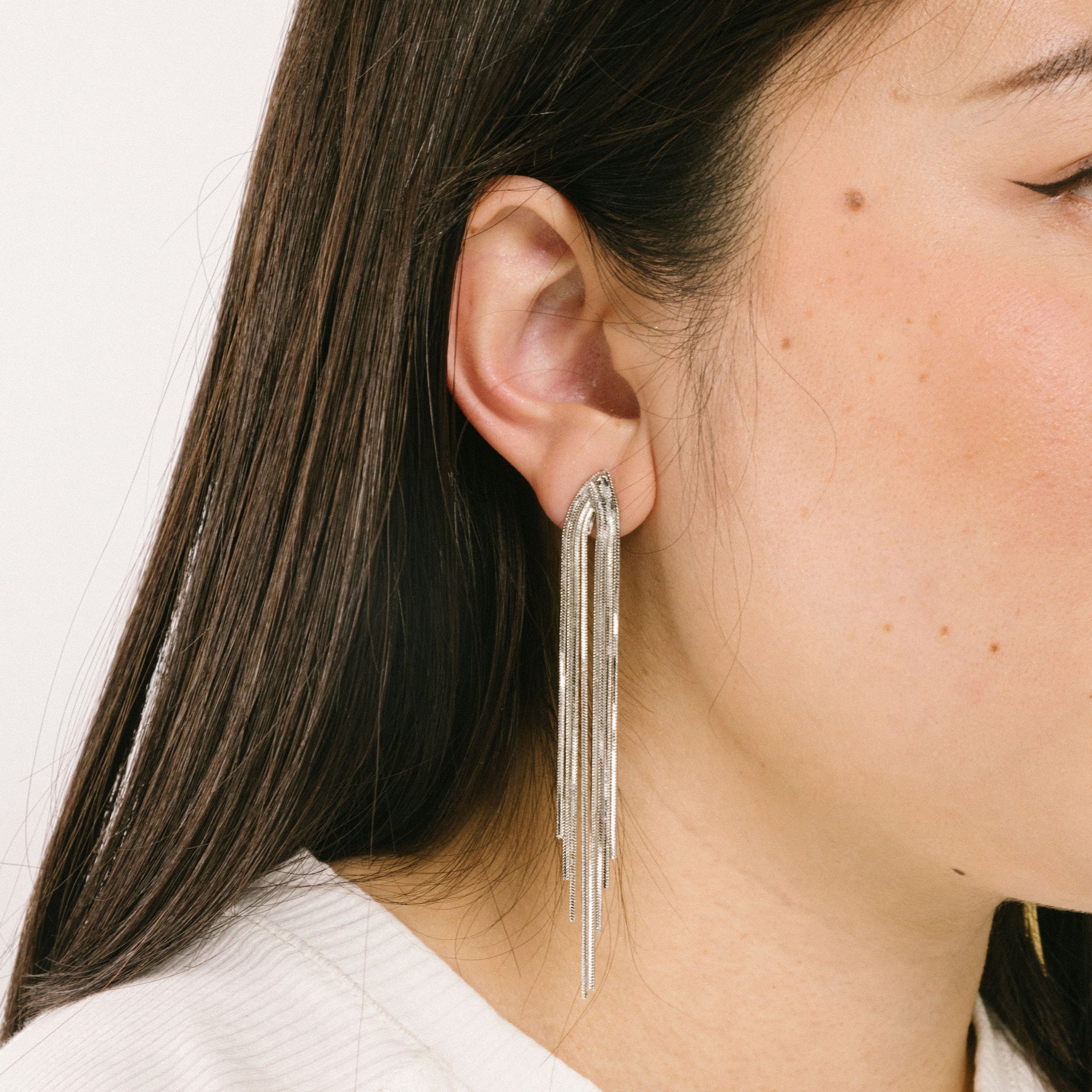 A model wearing the Chain Chandelier Clip On Earrings feature removable rubber padding, making them an optimal choice for all ear types. Whether you have thick/large, sensitive, small/thin or stretched/healing ears, this single pair can provide secure, yet comfortable wear.