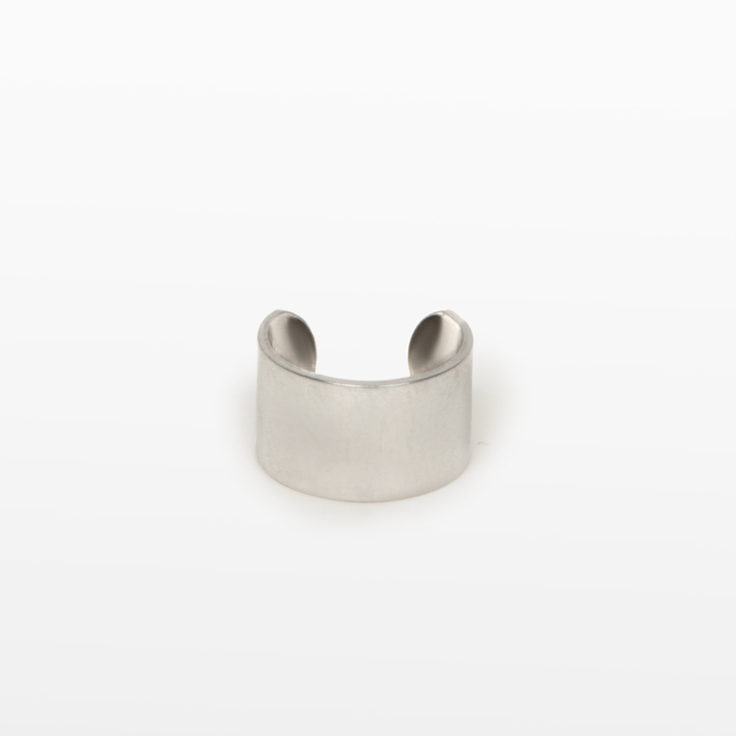 Image of the Cigar Band Ear Cuff, available in Silver, features a medium-strength secure hold and adjustable closure type. Crafted from Stainless Steel and Titanium, this cuff is suitable for use with all ear types, including thick/large ears, sensitive ears, small/thin ears, and stretched/healing ears. Please note, this item is sold as a single piece and is intended to be worn on the helix of the ear.