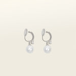 Image of the Claire Pearl Clip On Earrings in Silver present a mosquito coil clip-on closure crafted to accommodate all ear types—from thick/large to sensitive, from small/thin to stretched/healing—ensuring a comfortable fit. Intricately constructed from silver tone copper alloy, Cubic Zirconia, and Simulated Faux Pearl, these earrings add a sophisticated touch to any ensemble.