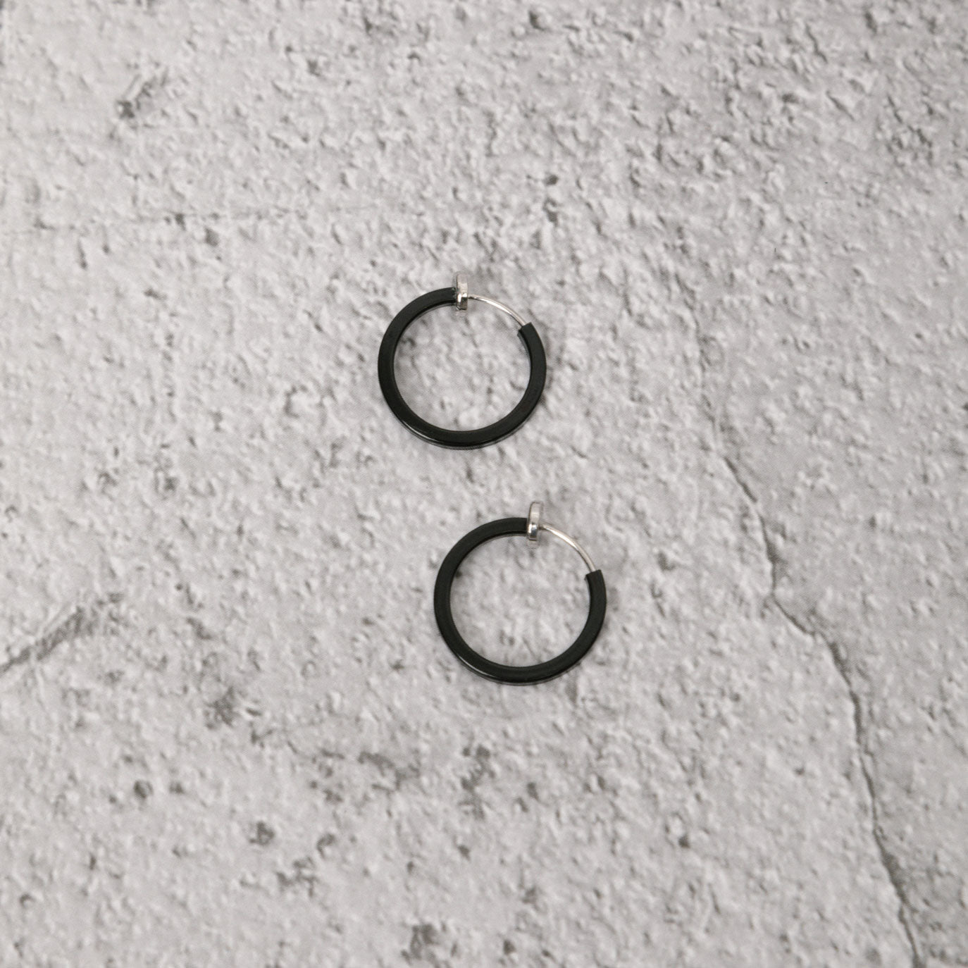 Image of the Classic Hoop Clip On Earrings feature a sliding spring closure that is ideal for small or thin ear lobes. The secure hold enables comfortable wear up to 4 hours, and the design automatically adjusts to the thickness of the ear. Crafted from stainless steel, the earrings come as a single pair.