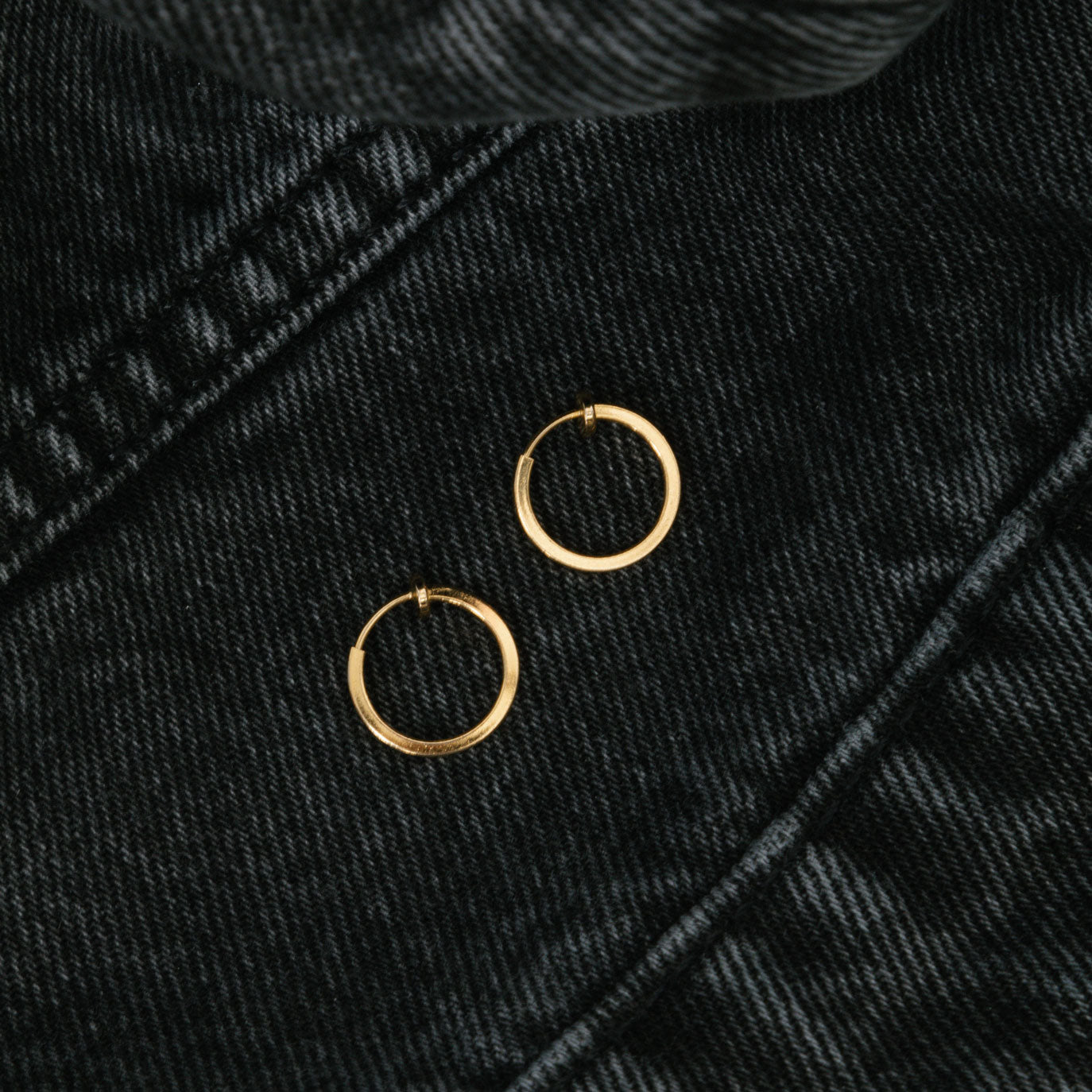 Image of the Classic Hoop Clip On Earrings feature a sliding spring closure that is ideal for small or thin ear lobes. The secure hold enables comfortable wear up to 4 hours, and the design automatically adjusts to the thickness of the ear. Crafted from stainless steel, the earrings come as a single pair.