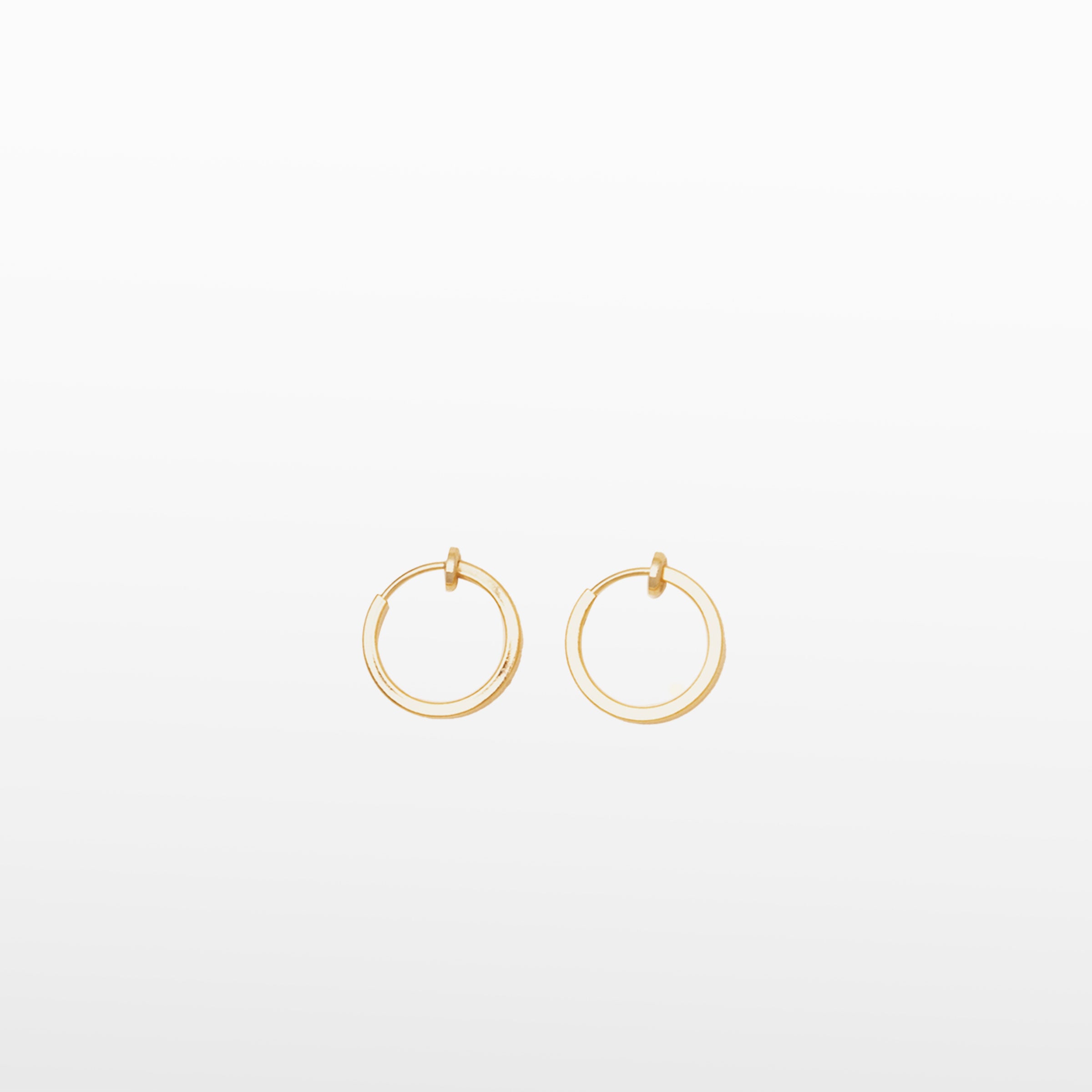 Image of the Classic Hoop Clip On Earrings feature a sliding spring closure that is ideal for small or thin ear lobes. The secure hold enables comfortable wear up to 4 hours, and the design automatically adjusts to the thickness of the ear. Crafted from stainless steel, the earrings come as a single pair.