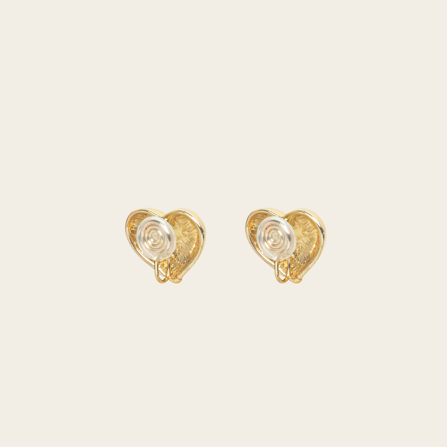 Image of the Coeur Clip On Earrings in Gold offer a medium-strength, adjustable hold via a mosquito coil clip. Ideal for all ear types, these earrings provide a secure yet comfortable fit for up to 24 hours. Crafted with Zinc Alloy and Copper, each purchase contains a single pair.