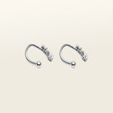 Image of the Constellation Ear Cuff in silver, a captivating and modern accessory that elevates your style. Crafted from copper alloy and available in gold or silver plating, this ear cuff boasts a celestial Constellation shape adorned with three sparkling cubic zirconia stars. Suitable for all genders, this stylish design is guaranteed to add an elegant and celestial touch to any outfit, making it a standout piece in your collection.