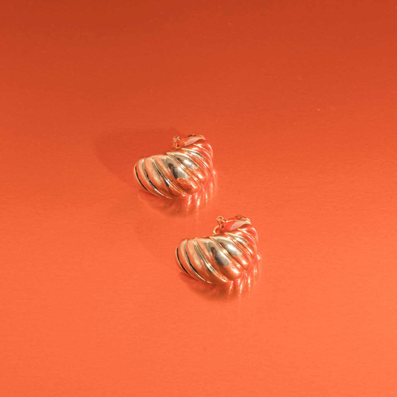 Image of the Croissant Dome Clip On Earrings in Gold are designed to provide a secure fit for all ear types. The rubber padding has a comfortable wear duration of 8-12 hours and is made with a Gold Tone Zinc Alloy. This item includes one pair.