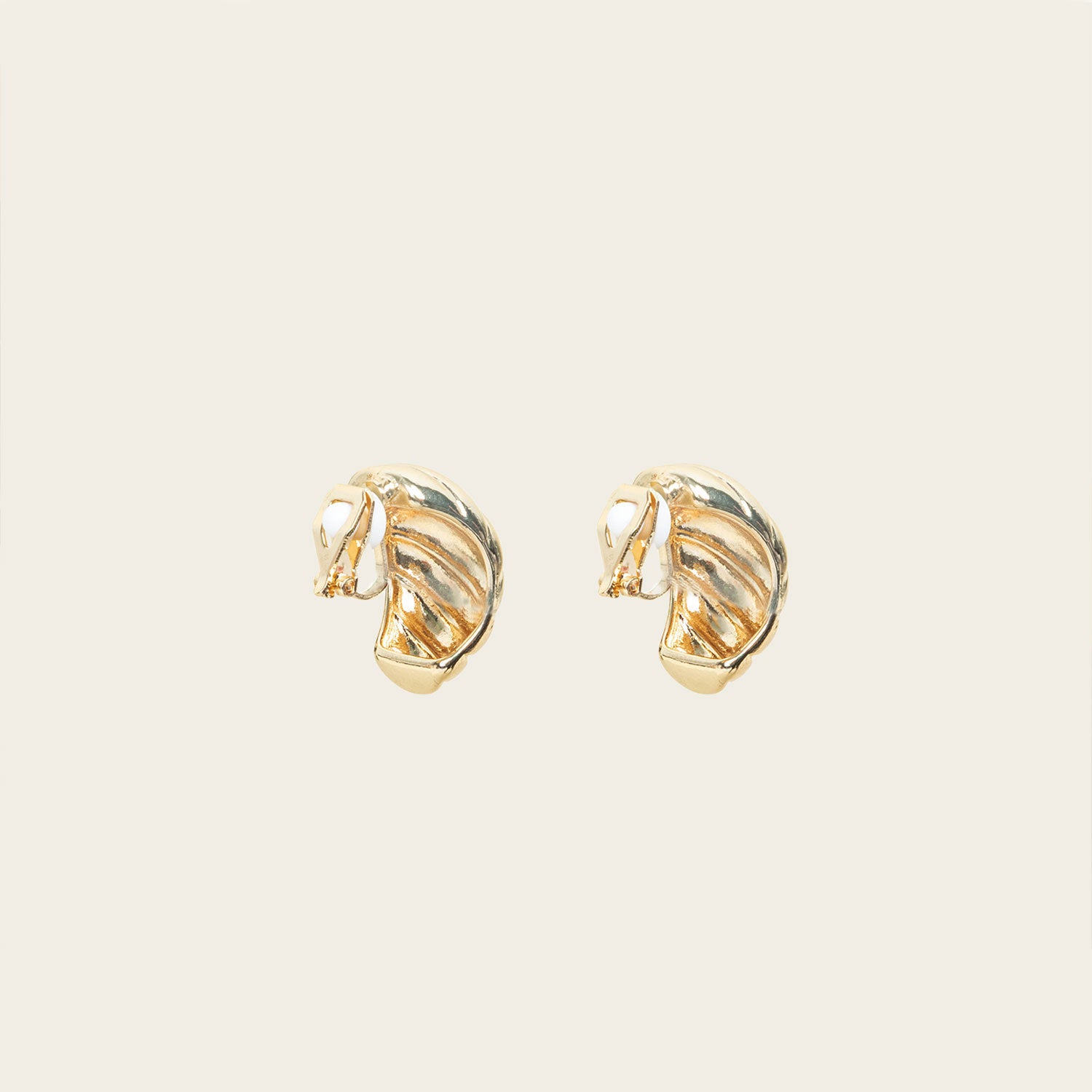 Image of the Croissant Dome Clip On Earrings in Gold are designed to provide a secure fit for all ear types. The rubber padding has a comfortable wear duration of 8-12 hours and is made with a Gold Tone Zinc Alloy. This item includes one pair.