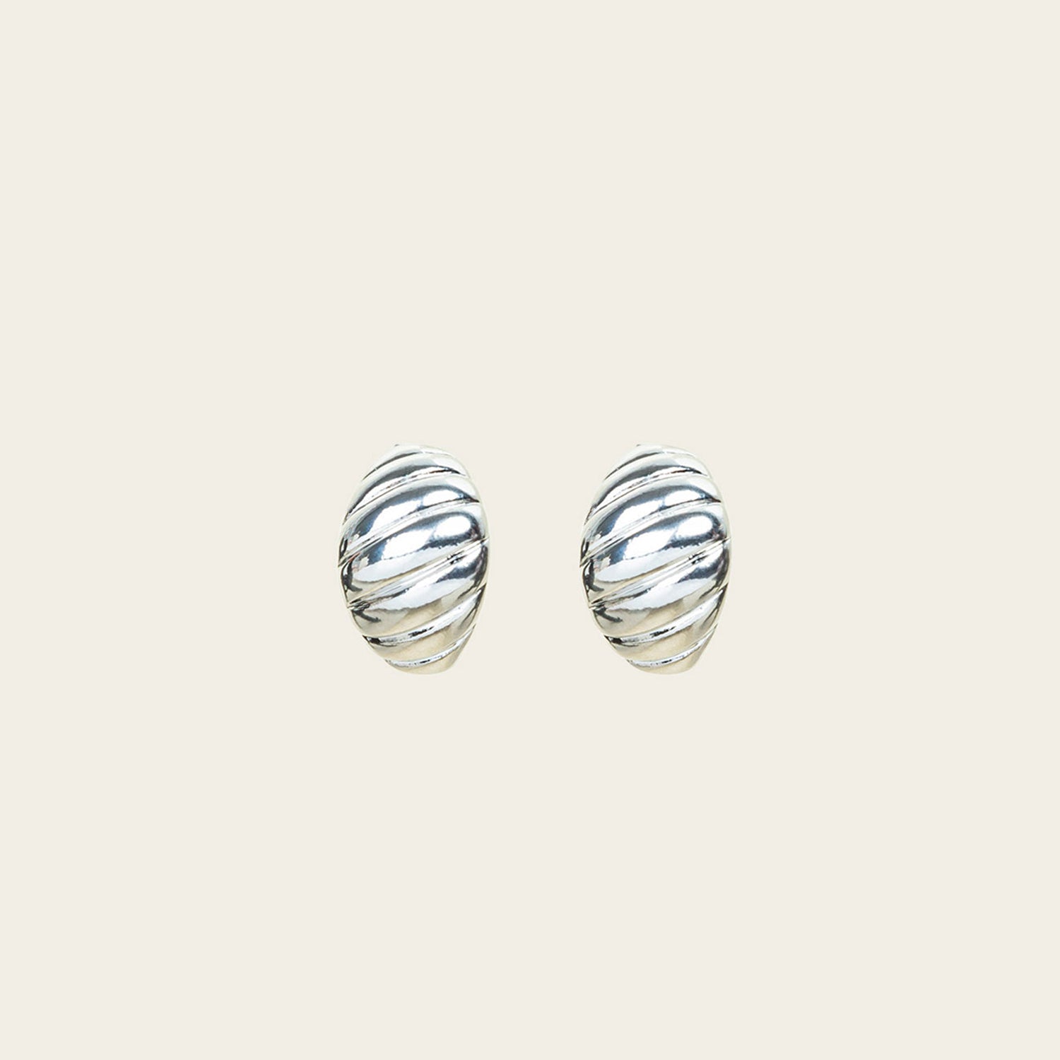 Image of the Croissant Dome Clip On Earrings in Silver are designed to provide a secure fit for all ear types. The rubber padding has a comfortable wear duration of 8-12 hours and is made with a Gold Tone Zinc Alloy. This item includes one pair.