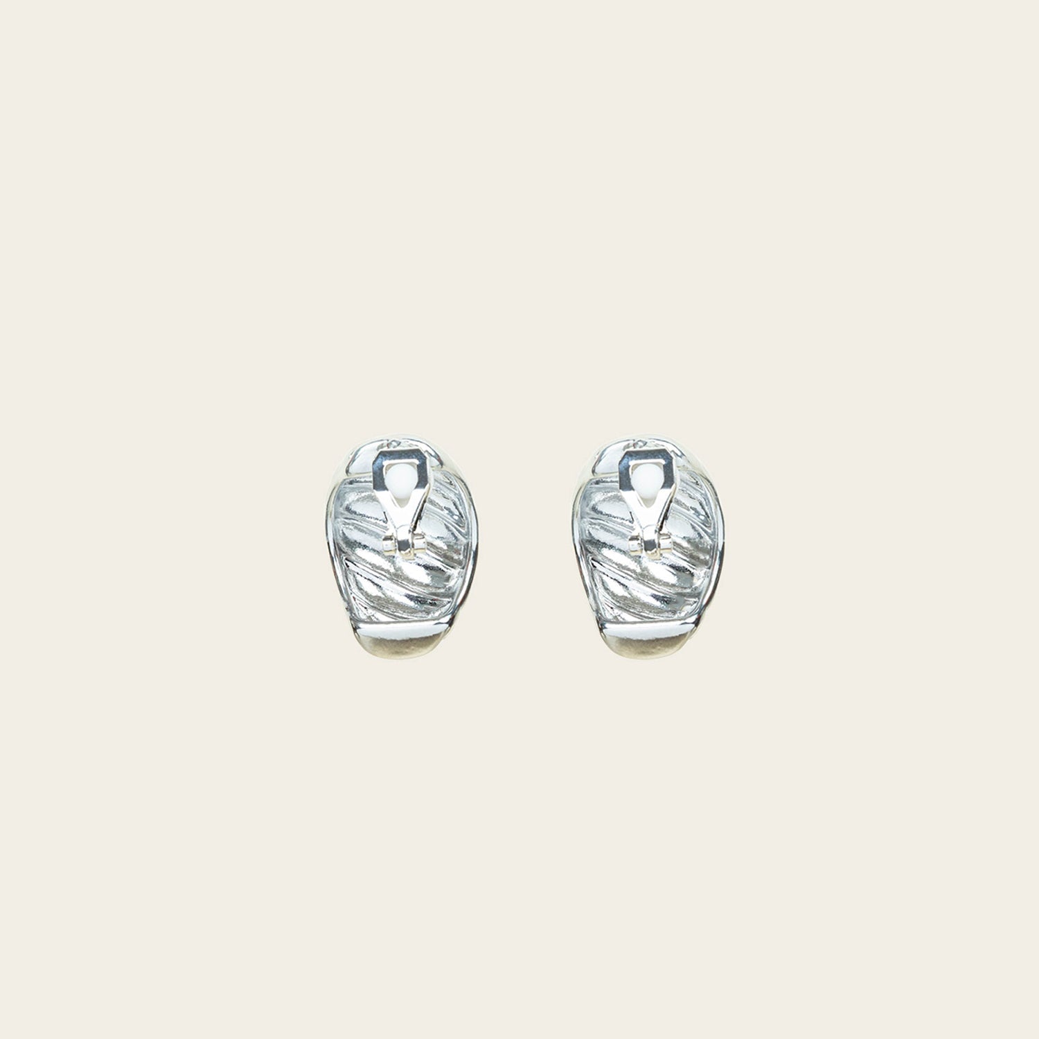 Image of the Croissant Dome Clip On Earrings in Silver are designed to provide a secure fit for all ear types. The rubber padding has a comfortable wear duration of 8-12 hours and is made with a Gold Tone Zinc Alloy. This item includes one pair.