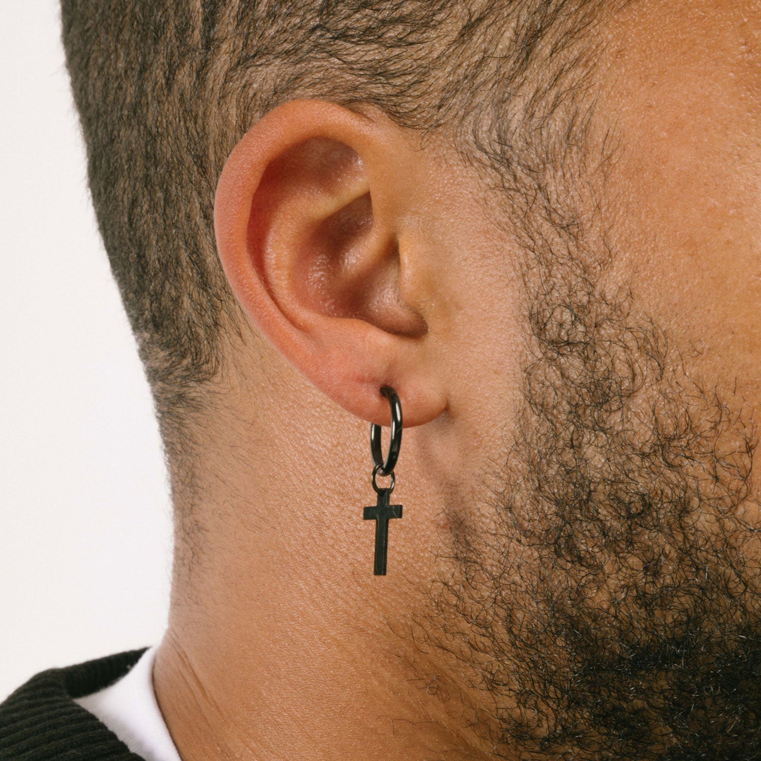 A model wearing the Cross Clip On Earrings are designed for small to thin earlobes. Their secure closure type sliding spring and adjustable features make them comfortable to wear for up to 4 hours. Made of stainless steel moreover, they are non-tarnish, water resistant, and free of lead, nickel, and cadmium.