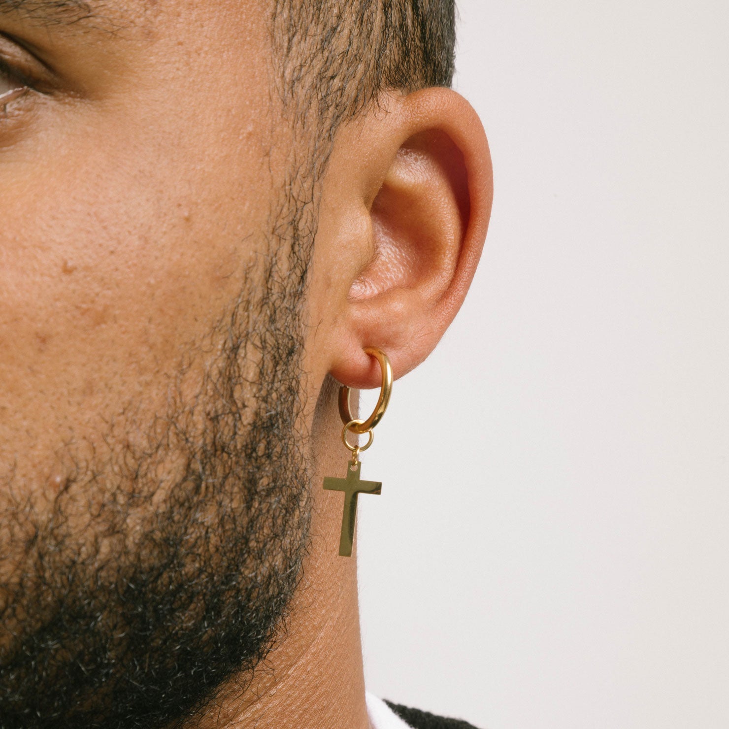 A model wearing the Cross Clip On Earrings are designed for small to thin earlobes. Their secure closure type sliding spring and adjustable features make them comfortable to wear for up to 4 hours. Made of stainless steel moreover, they are non-tarnish, water resistant, and free of lead, nickel, and cadmium.