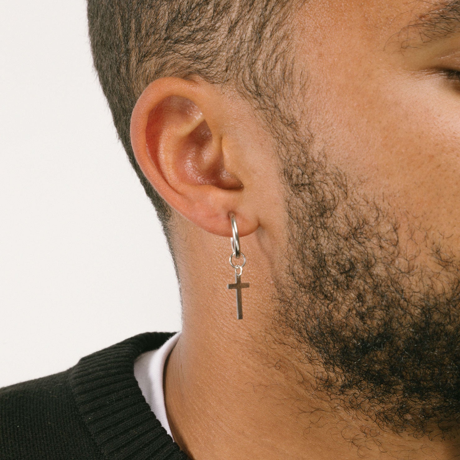 A model wearing the Cross Clip On Earrings are designed for small to thin earlobes. Their secure closure type sliding spring and adjustable features make them comfortable to wear for up to 4 hours. Made of stainless steel moreover, they are non-tarnish, water resistant, and free of lead, nickel, and cadmium.