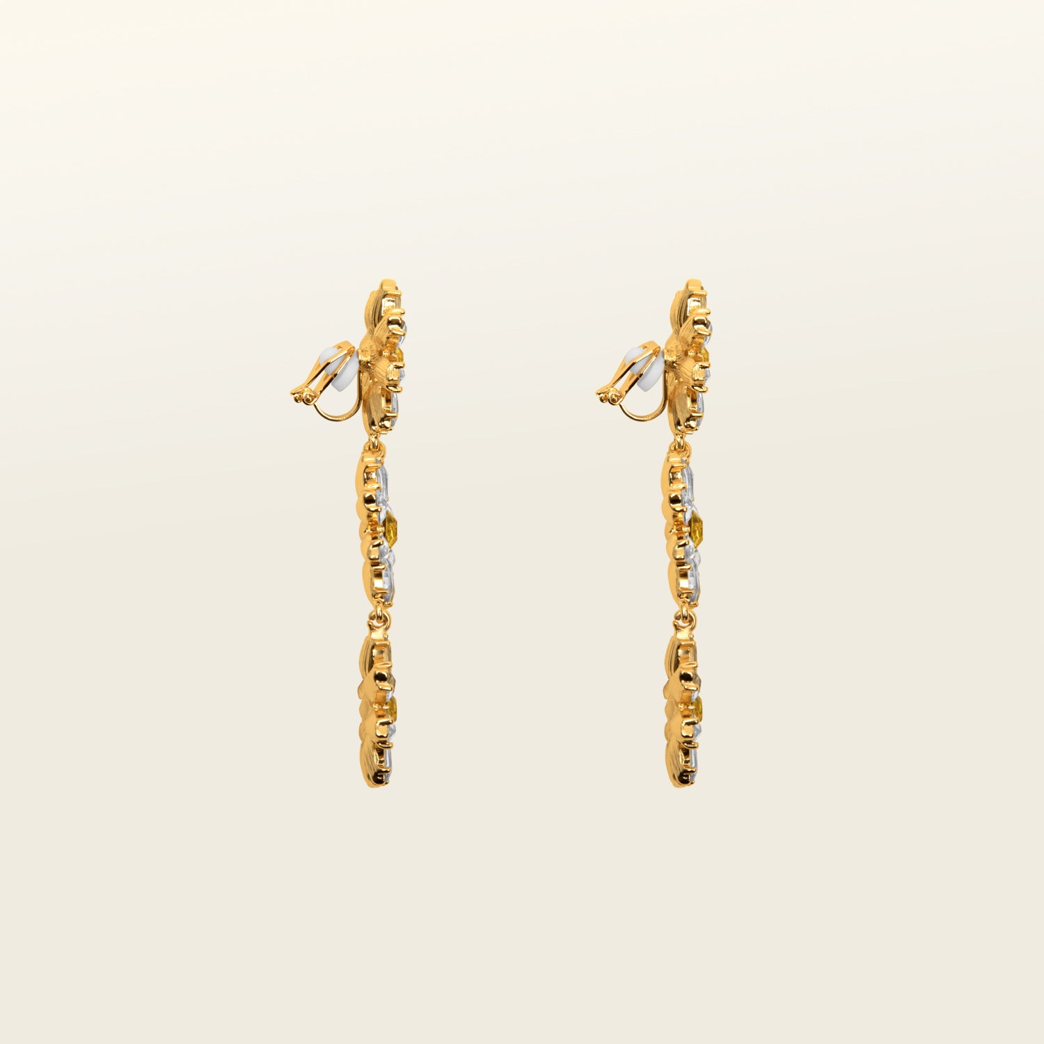 Image of the Crystal Flower Drop Clip On Earrings feature a Padded Clip-On closure, perfect for ears of larger proportions as the earrings are on the heavier side. Constructed of gold tone copper alloy and Rhinestone, with detachable rubber padding for added comfort, these earrings provide up to 8-12 hours of easy wear. Sold as one single pair.