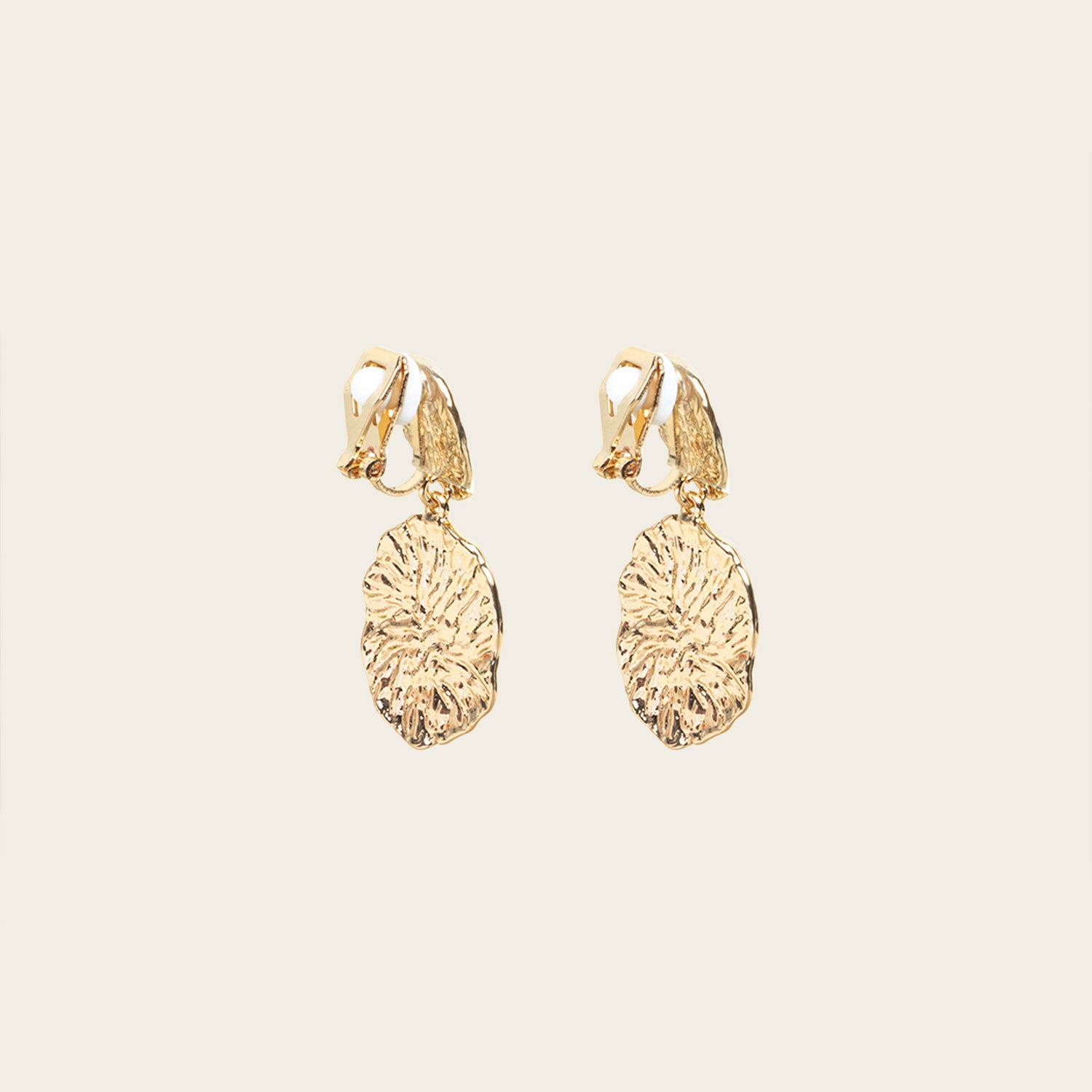 Image of the Daiquiri Drop Clip On Earrings in Gold feature a secure, padded clip-on closure ideal for all ear types, offering up to 12 hours of comfortable wear. Crafted from Zinc and Copper alloy, these earrings come as a single pair with removable rubber padding.