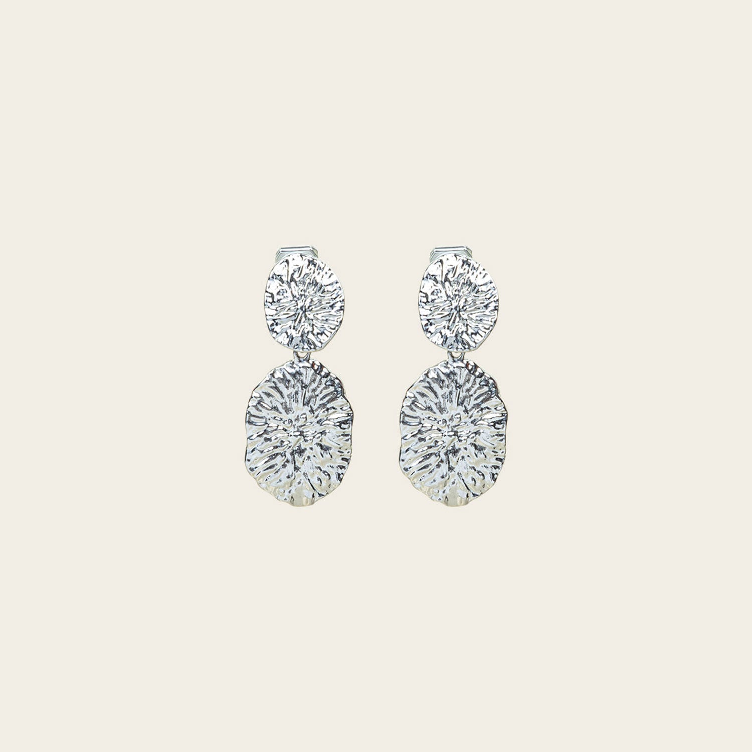 Image of the Daiquiri Drop Clip On Earrings in Silver feature a secure, padded clip-on closure ideal for all ear types, offering up to 12 hours of comfortable wear. Crafted from Zinc and Copper alloy, these earrings come as a single pair with removable rubber padding.