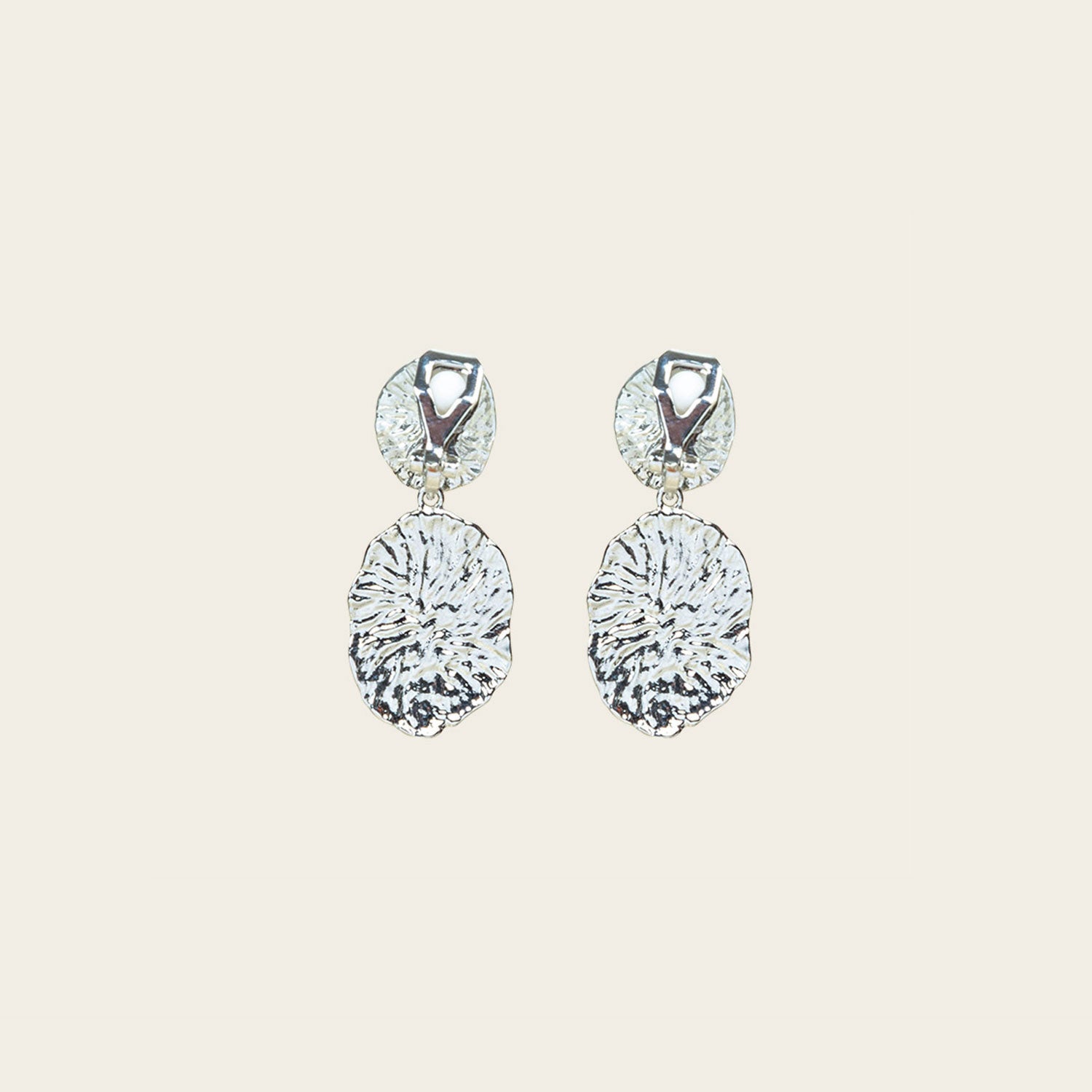 Image of the Daiquiri Drop Clip On Earrings in Silver feature a secure, padded clip-on closure ideal for all ear types, offering up to 12 hours of comfortable wear. Crafted from Zinc and Copper alloy, these earrings come as a single pair with removable rubber padding.