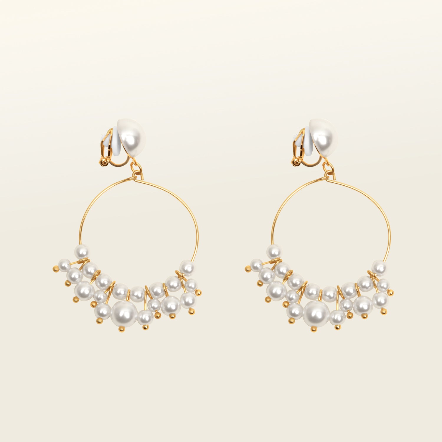 Image of the Delphine Clip On Earrings feature a gold-tone copper alloy and a Simulated Faux Pearl. The closure type is a padded clip-on earring with removable rubber padding, making it ideal for all ear types (including thick/large ears, sensitive ears, small/thin ears, and stretched/healing ears). You can expect a secure hold for up to 12 hours of comfortable wear. Please note that this item is sold as a single pair.