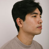A model wearing the Silver Double Chain Ear Cuff is designed for a comfortable and secure fit on all ear types. You can easily adjust it to your desired level of hold strength, and it will stay in place for up to 24 hours. The cuff is crafted from a silvertone plated zinc alloy material. Please note that the item is sold as a single piece.