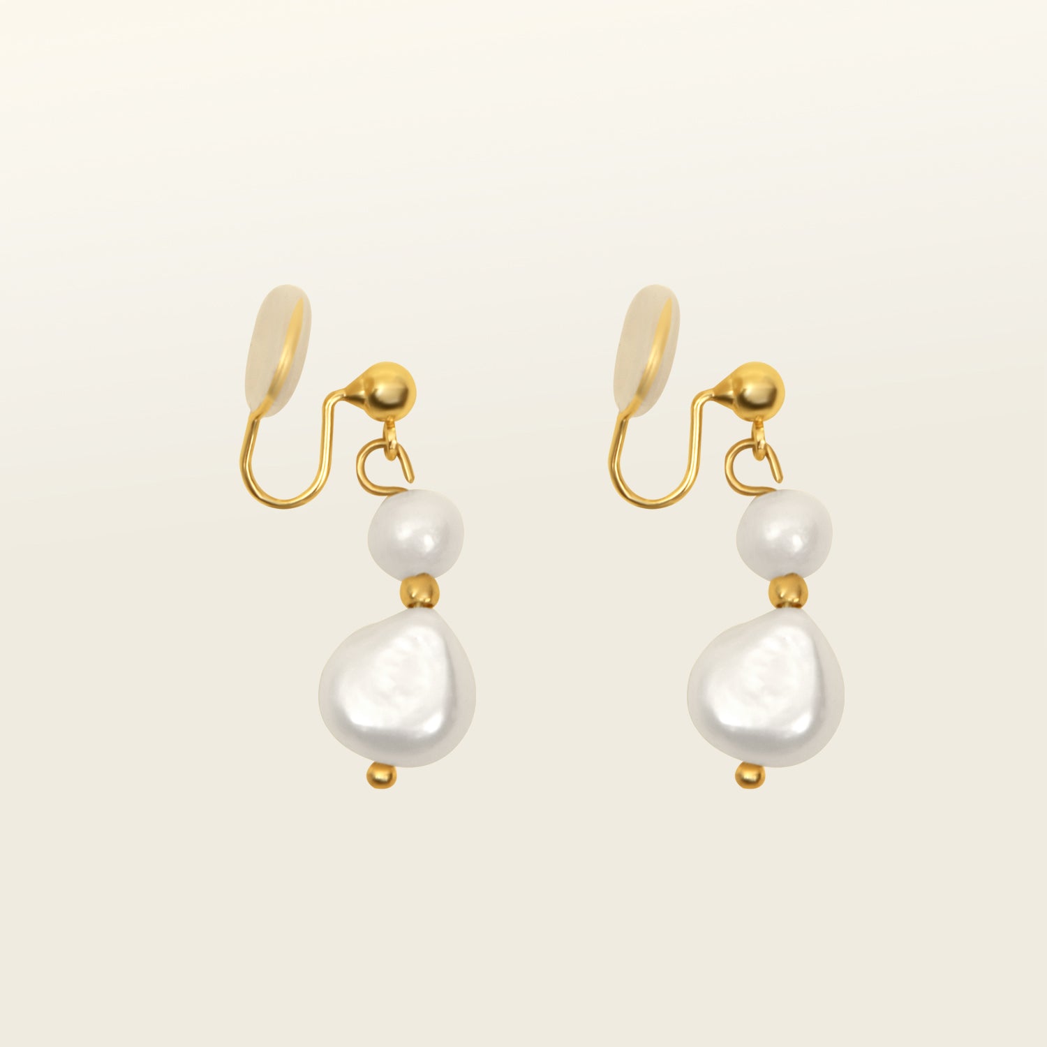 Image of the Duo Pearl Clip-On Earrings in Gold feature a mosquito coil clip-on closure ideal for all ear types. Enjoy medium secure hold and comfortable wear for up to 24 hours - gently squeezing the padding forward once on the ear for adjustable fit. Crafted with freshwater pearls and 18K gold plated stainless steel, each piece features unique natural variations in size and colour.